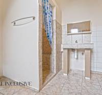 NA PREDAJ 4-IZBOVÝ RODINNÝ DOM V OBCI MOSTOVÁ - Kúpeľňa v rodinnom dome s dlažbou a jednoduchým sprchovacím kútom.