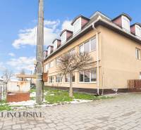 NA PREDAJ ŠKOLSKÁ BUDOVA NA VEĽKOM POZEMKU, MOSTOVÁ - Budova v Mostovej s modernými architektonickými prvkami a parkoviskom na ulici.