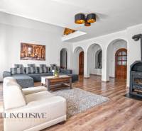 REZERVOVANÉ ZREKONŠTR. 6 IZBOVÝ RODINNÝ DOM, KOŠÚTY - Obývačka v rodinnom dome s krbom, oblúkmi a podlahou s dreveným dekorom.