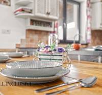 NA PREDAJ 4-IZB NOVOSTAVBA S TROJGARÁŽOU, PIN. KRAČANY - Jemne prestretý stôl v Rodinnom dome s podlahou s dreveným dekorom a kuchyňou.