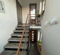 Na predaj 5-izb. rodinný dom na 50-á pozemku, Sap - Schodisko v rodinnom dome s dekoráciami, kresbou na stene a dreveným zábradlím.