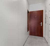 | Krásny a moderný 2-izbový byt | 51,50m² | - Vstupná chodba v 2-izbovom byte s bielymi stenami a tmavými dverami.