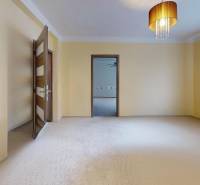 Prerobený rodinný dom na veľkom tichom pozemku v obci Pruské   - Svetlá izba v rodinnom dome so záclonami, lustrom a otvorenými dverami.