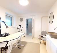 Novozariadený rodinný dom s veľkými spálňami i šatníkom pri Trenčíne   - Interiér rodinného domu s masážnym stolom, umývadlo, zrkadlo a stoličky.