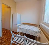 Prenájom 2-izbového bytu v Poprade na Dostojevského ul. - Jedáleň v 2-izbovom byte s podlahou s dreveným dekorom a bielou chladničkou.