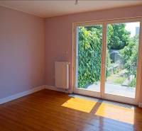 Rodinný dom s veľkou záhradou - Ružinov  - Izba v rodinnom dome s podlahou s dreveným dekorom a výhľadom na záhradu.