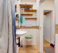 2 byty v 1 už s nájomníkmi | okamžitý príjem 1770€/mes | 4.08% - Kúpeľňa s toaletou, umývadlom, sprchovým závesom a regálmi v 5 a viac izbovom byte.