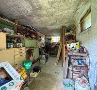 Predaj domu v Janovej Lehote - Kotoľňa s regálmi a nástrojmi v rodinnom dome, úložné priestory plné rôznych predmetov.