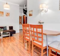  VÝNIMOČNÝ 4-izbový byt rozdelený na DVA SAMOSTATNÉ BYTY - Obývacia izba s pohovkou, stolom a podlahou s dreveným dekorom v 4-izbovom byte.