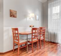  VÝNIMOČNÝ 4-izbový byt rozdelený na DVA SAMOSTATNÉ BYTY - Jedálenský kút so stolom a stoličkami, podlaha s dreveným dekorom v 4-izbovom byte.