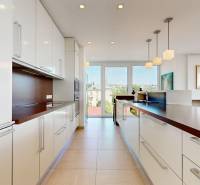 Exkluzívny byt pod Slavínom s terasou a výhľadom na Bratislavu - Kuchyňa v 4-izbovom byte s veľkými oknami, svetlými skrinkami a funkčným osvetlením.