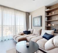 RIVERS | Butikovo zariadený ateliér na 32. poschodí Eurovea Tower - Obývacia izba v 2-izbovom byte s pohovkou, poličkami a podlahou s dreveným dekorom.