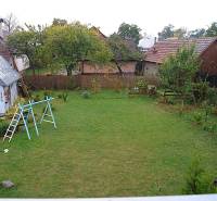Zrekonštruovaný rodinný dom s peknou záhradou, Bystrička - Záhrada s trávnikom a drevenou stavbou pri rodinnom dome v Bystričke.