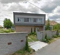 Zrekonštruovaný rodinný dom s peknou záhradou, Bystrička - Rodinný dom v Bystričke s upravenou záhradou a vysokým plotom pozdĺž ulice.