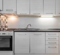 I Predaj 3- izbového bytu v Dúbravke - Kuchynská linka v 3-izbovom byte s keramickým obkladom a bielou rúrou.