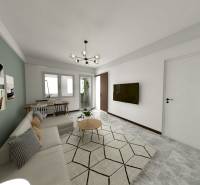 I Predaj 3- izbového bytu v Dúbravke - Obývacia izba v 3-izbovom byte so sivou podlahou a zelenou stenou.