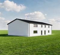 Predaj, výrobný a veľkoobchodný areál v okrese Veľký Krtíš - Výrobné priestory v meste Veľký Krtíš na zelenej lúke s modrou oblohou.