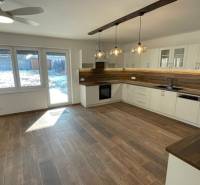 Rodinný dom na Devätinovej ulici na prenájom - Kuchyňa v rodinnom dome s dreveným dekorom podlahy a moderným osvetlením.