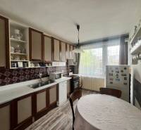 Exk. viacgeneračný RD vo Veľkom Orvišti pri Piešťanoch REZERVOVANÝ - Kuchyňa v rodinnom dome s drevenými skrinkami, okrúhlym stolom a podlahou s dreveným dekorom.