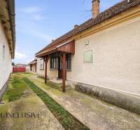 Na predaj 4-izbový rodinný dom, Topoľníky - Rodinný dom v Topoľníkoch s udržiavanou fasádou, verandom a betónovým chodníkom.