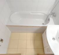 | 2-izbový byt + parking, ul. Východná | Trenčín - Kúpeľňa v 2-izbovom byte s vaňou, umývadlom a bielym obkladom.