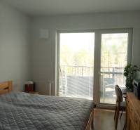 VÝMENA! Nový 2+kk s park. miestom a lodžiou za 3+1, Rača, Bratislava - Spálňa v 2-izbovom byte s posteľou a balkónom, podlaha s dreveným dekorom.