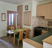 PRENÁJOM 3 izbový zariadený byt,  Nitra - Diely - Kuchyňa v 3-izbovom byte s jedálenským stolom a drevenými skrinkami.
