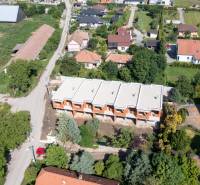 NA PREDAJ ‼️POSLEDNÉ 2 ‼️- 4 izbové radové domy v Ivánke pri Nitre - Výstavba domov, ulica, zeleň a rodinné domy v oblasti, letecký pohľad.