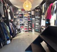 Priestranný 5-izbový rodinný dom s pohodlným dojazdom do Bratislavy  - Šatník v rodinnom dome s policami na topánky a oblečenie.