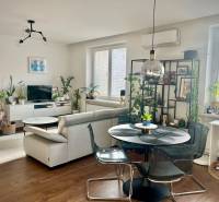 Prenájom 2,5 izbový byt, Trenčianska ulica, Bratislava II. Ružinov - Obývačka v 2-izbovom byte s podlahou s dreveným dekorom a množstvom rastlín.