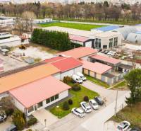 PRAKTICKÉ SKLADOVÉ PRIESTORY  | DOPRAVNÁ | TOPOĽČANY - Oblasť plná budov so skladmi a halami na ulici Dopravná, obklopená zeleňou a parkovaním.