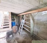 Pôvodný domček v obci Nová Vieska - Suterén rodinného domu v Novej Vieske s kovovým rebríkom a nádržou na vodu.