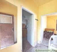 Pôvodný domček v obci Nová Vieska - Žlté steny, vstupná chodba, izby, nábytok, plastová stolička v rodinnom dome.