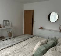 - PRENÁJOM - 2 IZBOVÝ BYT - DOLNÁ UL. - STARÉ MESTO - Spálňa v 2-izbovom byte s bielym nábytkom a posteľou s vankúšmi.