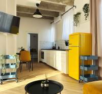 - PRENÁJOM - 3 IZBOVÝ BYT - WILSONOVA UL. - STARÉ MESTO - Interiér 3-izbového bytu s podlahou s dreveným dekorom, žltou chladničkou a bielou kuchynskou linkou.