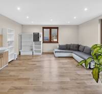 Rodinný dom s veľkým pozemkom a priestorom na podnikanie – T.Jastrabie - Obývacia izba s rohovou sedačkou, podlahou s dreveným dekorom a svetlými stenami v rodinnom dome.