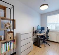 PREDAJ, 3 izbový dizajnový byt na Lidickom námestí, Košice - Furča - Domáca kancelária v 3-izbovom byte s poličkami, stolom a podlahou s dreveným dekorom.