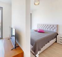 Nový, ešte neobývaný 1,5-izbový byt, parkovanie, Metropolis, Bottova - Dvojlôžková spálňa v 2-izbovom byte s podlahou s dreveným dekorom a balkónom.