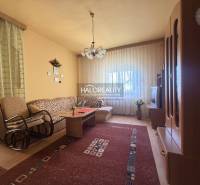 Predaj, rodinný dom Dvory nad Žitavou, päťizbový  - Obývacia izba v rodinnom dome s pohodlnou sedačkou a podlahou s dreveným dekorom.