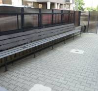 PRENÁJOM NEB.PRIESTORU V POLYFUNKČNOM DOME V CENTRE PEZINKA - Dlhá lavička na Moyzesovej ulici pred obchodnými priestormi s dlažbou a zábradlím.