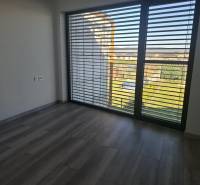 Moderný rodinný dom so záhradou, bazénom a nadštandardným priestorom - Interiér v rodinnom dome s veľkými oknami a podlahou s dreveným dekorom.