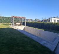 Moderný rodinný dom so záhradou, bazénom a nadštandardným priestorom - Záhrada rodinného domu v Zvončíne s pergolou a nedokončeným bazénom.