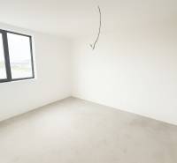 4-izbový rodinný dom Galanta – HODY - bez rezervačnej zálohy - Prázdna miestnosť v rodinnom dome s veľkým oknom a nedokončenou podlahou.