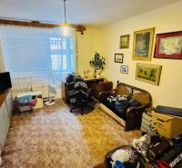 Na predaj 3 i  byt s loggiou aj terasou - Prievidza 75,24 m2 - Obývacia izba v 3-izbovom byte s dekoráciami, nábytkom a podlahou s dreveným dekorom.