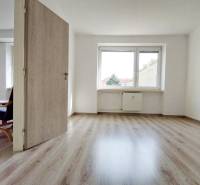 Na PRENÁJOM, VEĽKÝ 2 izb. TEHLOVÝ BYT, SÍDLISKO II., PREŠOV  - Interiér 2-izbového bytu s podlahou s dreveným dekorom a svetlými stenami.