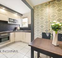 Na predaj 4-izb. byt s loggiou , Dunajská Streda - Kuchyňa v 4-izbovom byte s bielymi skrinkami, vstavanou rúrou a kvetinovou tapetou.