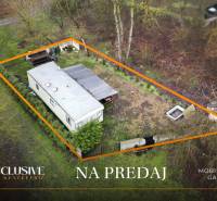 Na predaj 3-izb. mobilný dom pri Gabčíkovskom ramene - Mobilný dom v Gabčíkove, obklopený zeleňou a jasne vyznačeným pozemkom na predaj.