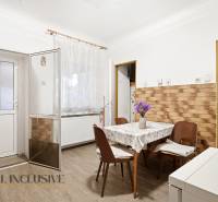 Na predaj 4-izb. rodinný dom s garážou, Okoč - Jedáleň v rodinnom dome s podlahou s dreveným dekorom a kvetmi na stole.