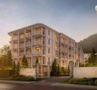 BIANCANA PHUKET - Výstavba bytov v Phuket, elegantná budova obklopená zeleňou za súmraku.