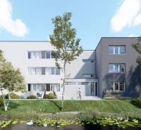 Pozemok s rozostavanou stavbou pre 12 bytov pri Senici - Na obrázku je bytový dom pri jazierku, zeleň a developerské pozemky.